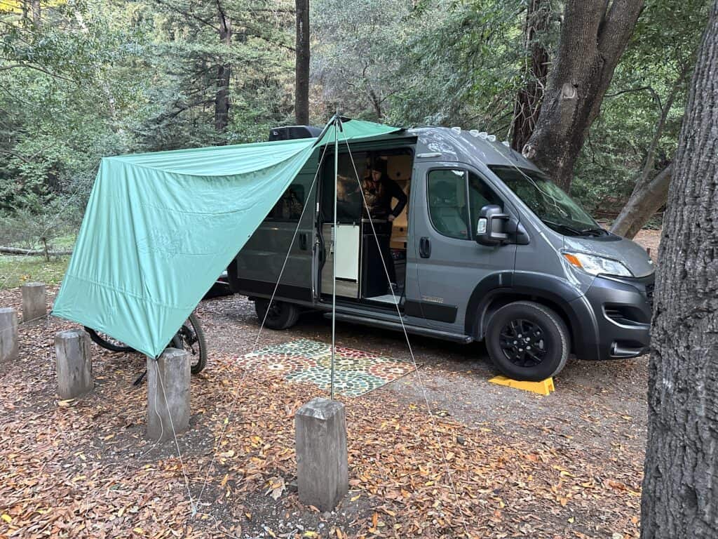 green canopy attached to a camper van