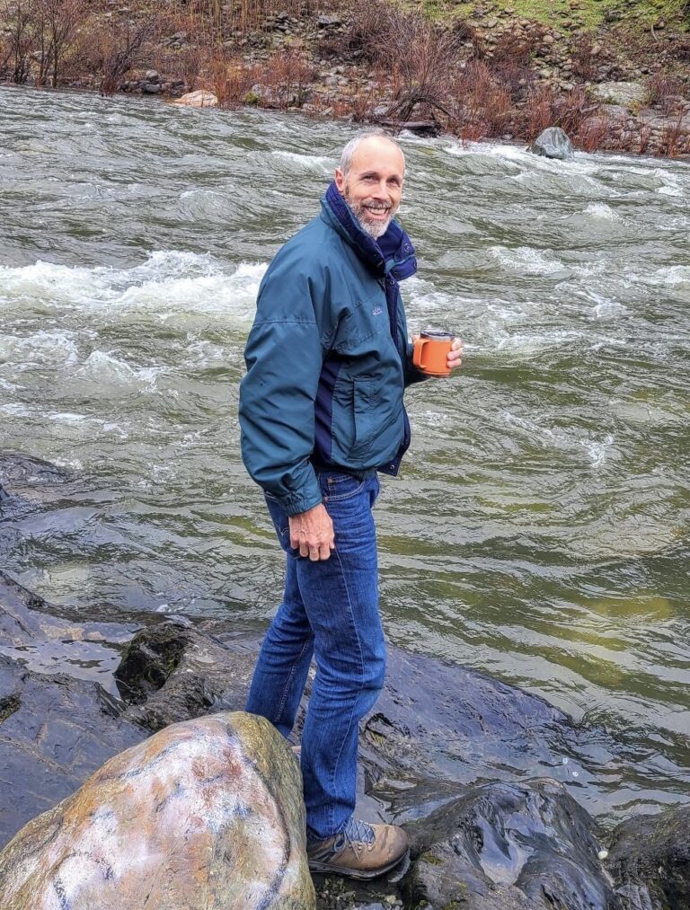 Steve standing by the river