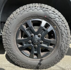 Promaster black wheel and tire with black lug nut covers